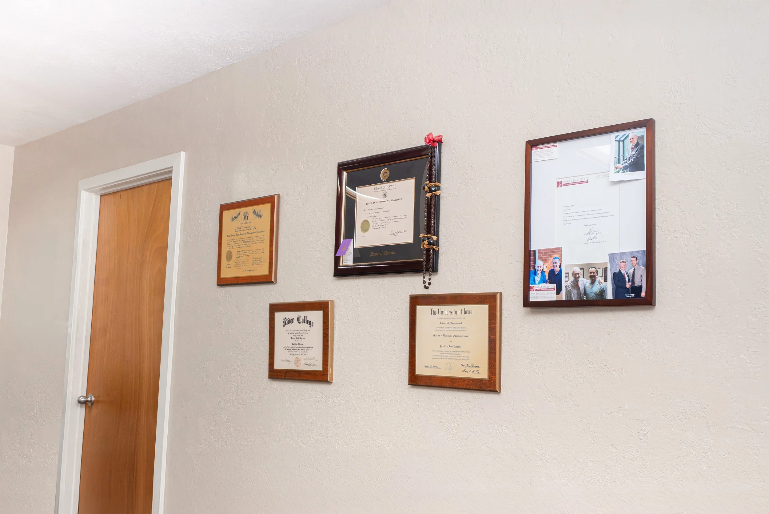 Framed chiropractic diplomas and certifications of Dr. Kevin Perrino displayed at the Head and Neck Center of Hawai‘i.