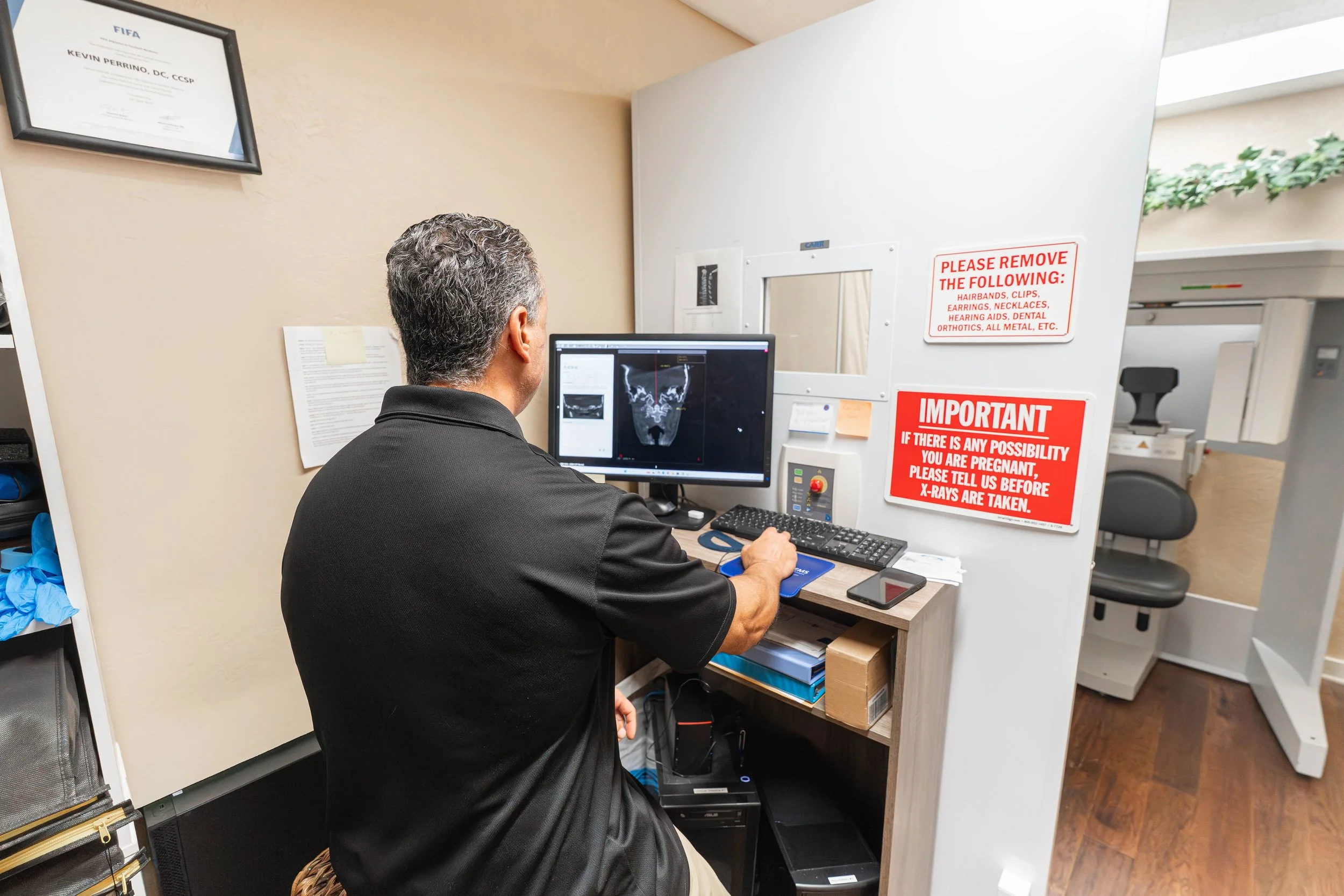 Dr. Kevin Perrino, DC reviewing Cone Beam CT imaging for atlas alignment at the Head and Neck Center of Hawai‘i in Kona.