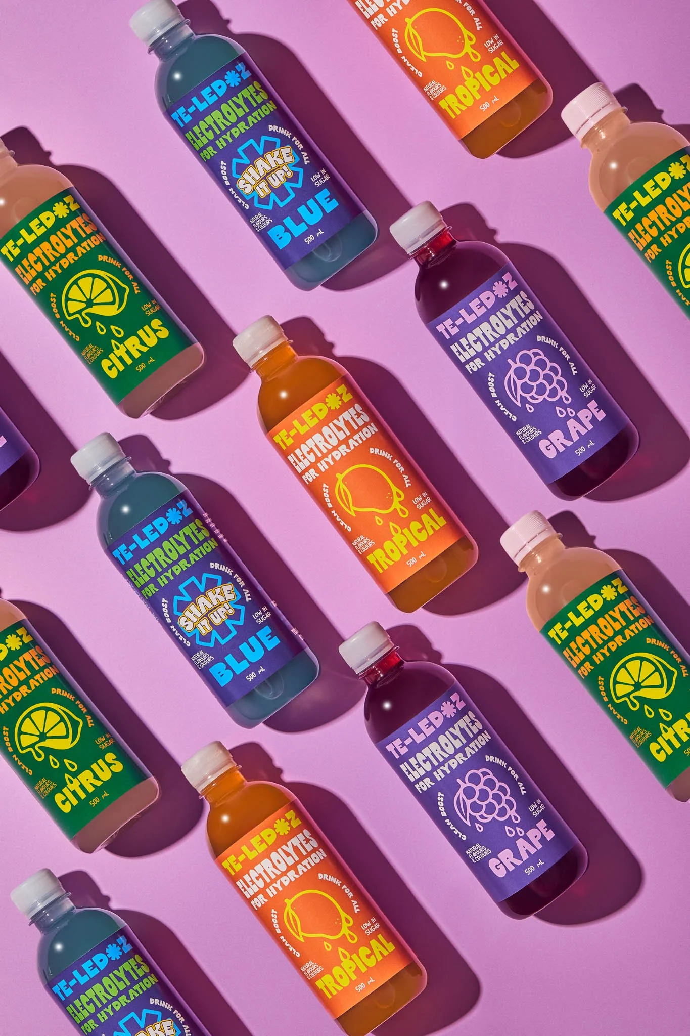 All four flavours of TE-LEDOZ lined up against a bright pink background