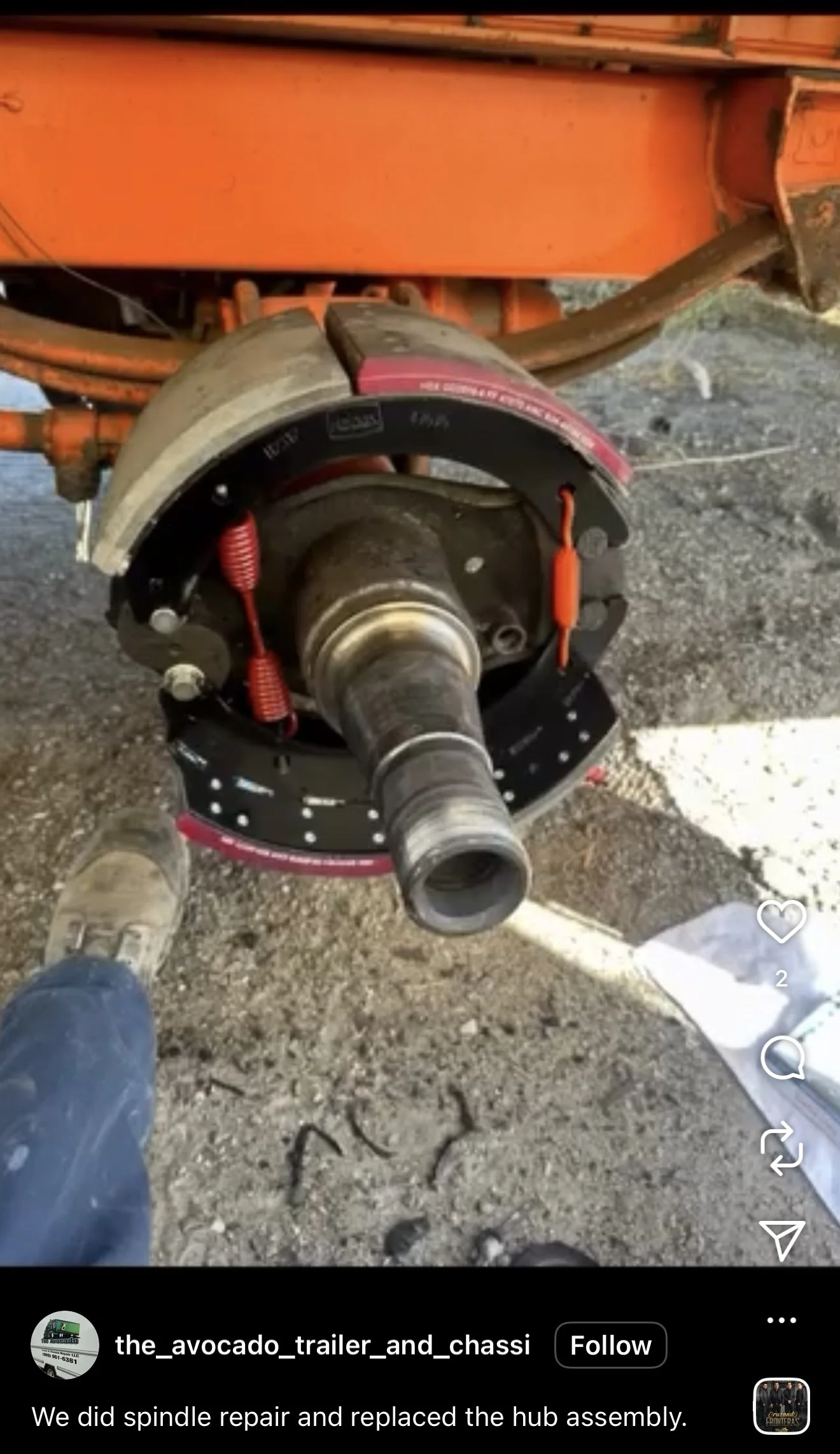 Close-up of a vehicle hub assembly with a new hub assembly being installed, showing brake shoes, springs, and the axle.
