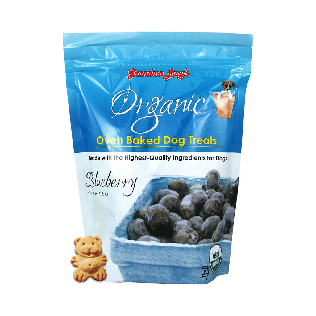 Bag of Grandma Lucy's Organic Oven Baked Dog Treats with blueberries, featuring a cartoon dog and a small dog-shaped biscuit.