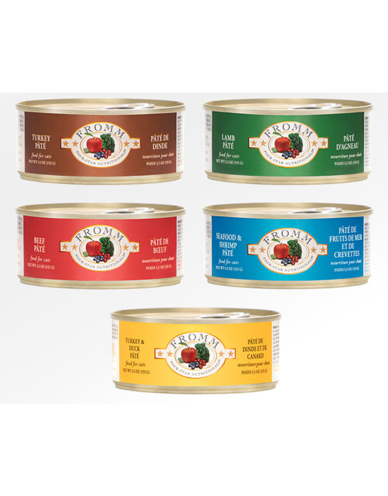 Five cans of cat food with different flavors and labels, including turkey, lamb, beef, seafood & shrimp, and turkey & duck.