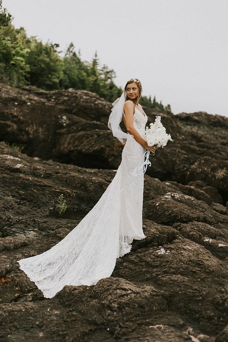 A bride has her photo taken at Presque Isle Park in Marquette