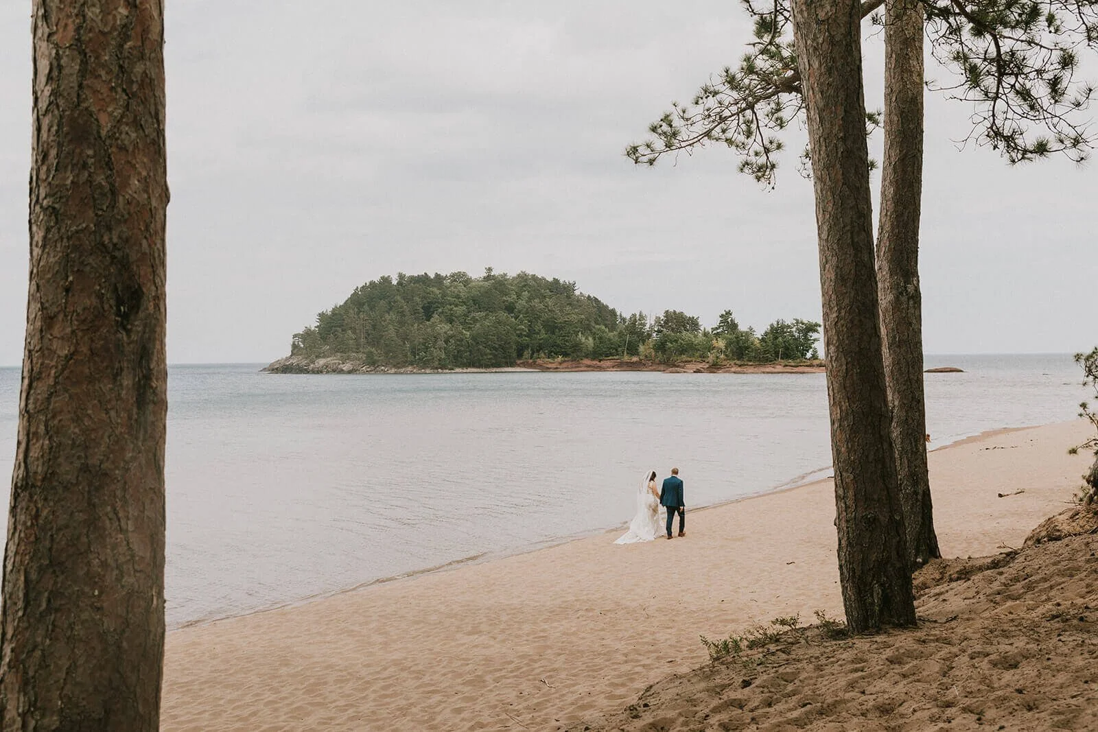 A couple walking on Little Presque Isle in Marquette Michigan