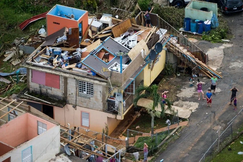 Aftermath and destruction of Hurricane Maria with a house with no roof.