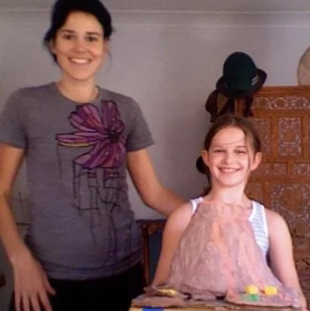 Eva Luna Ortiz and her mother Laura Salwet pose with a model of a clay Volcano science experiment.