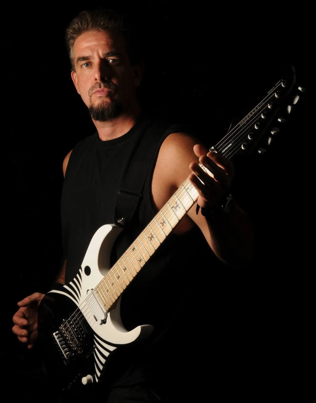 Ramon Ortiz Guitar (aka RO7) appears holding his electric 7 string yin-yang design signature guitar in 2009