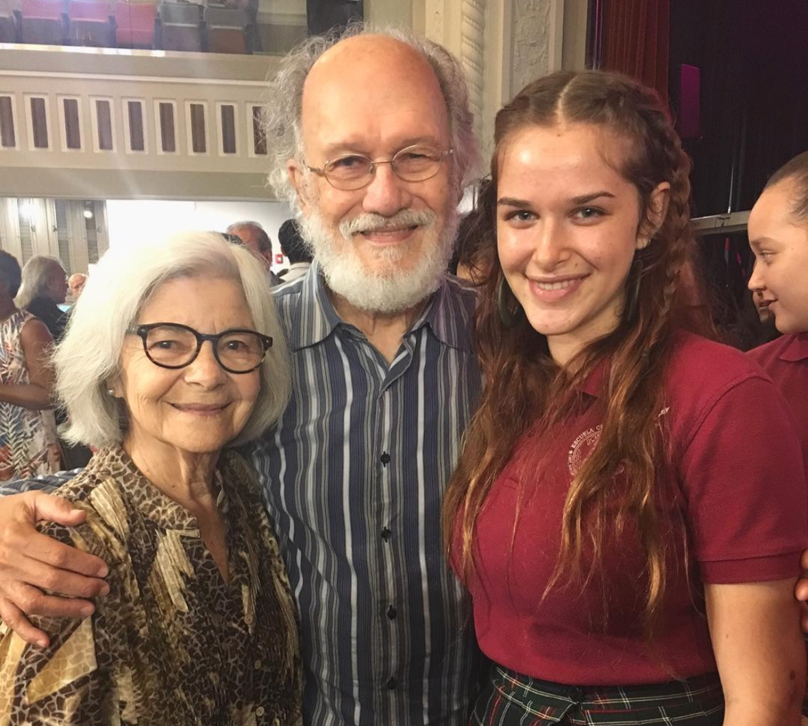 16 year old Eva Luna Ortiz posing with puerto-rican director and filmmaker Jacobo Morales and his wife Blanca Eró at a school theatre in 2016