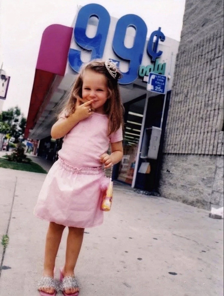 3 year old Eva Luna Ortiz poses in a pink princess outfit in front of a 99 cents store in Hollywood 2003