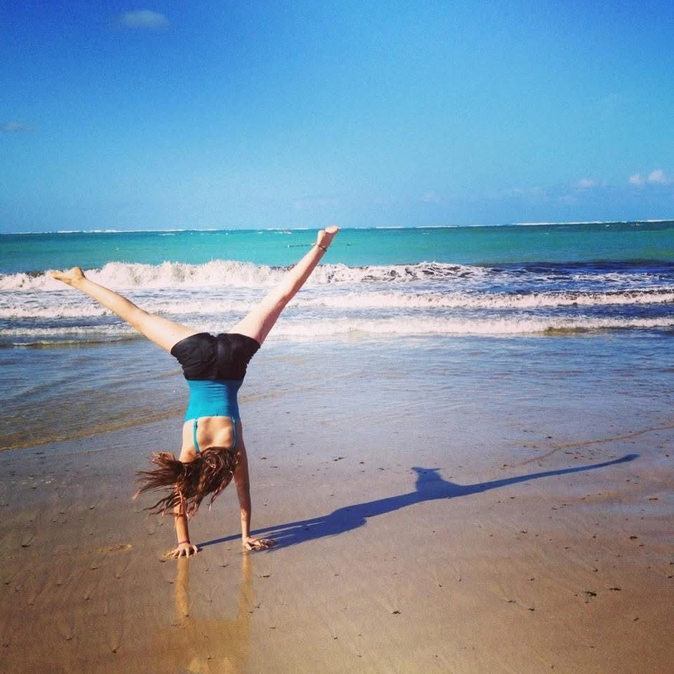 12 year old Eva Luna Ortiz doing a cartwheel on the beach of Isla Verde Puerto Rico