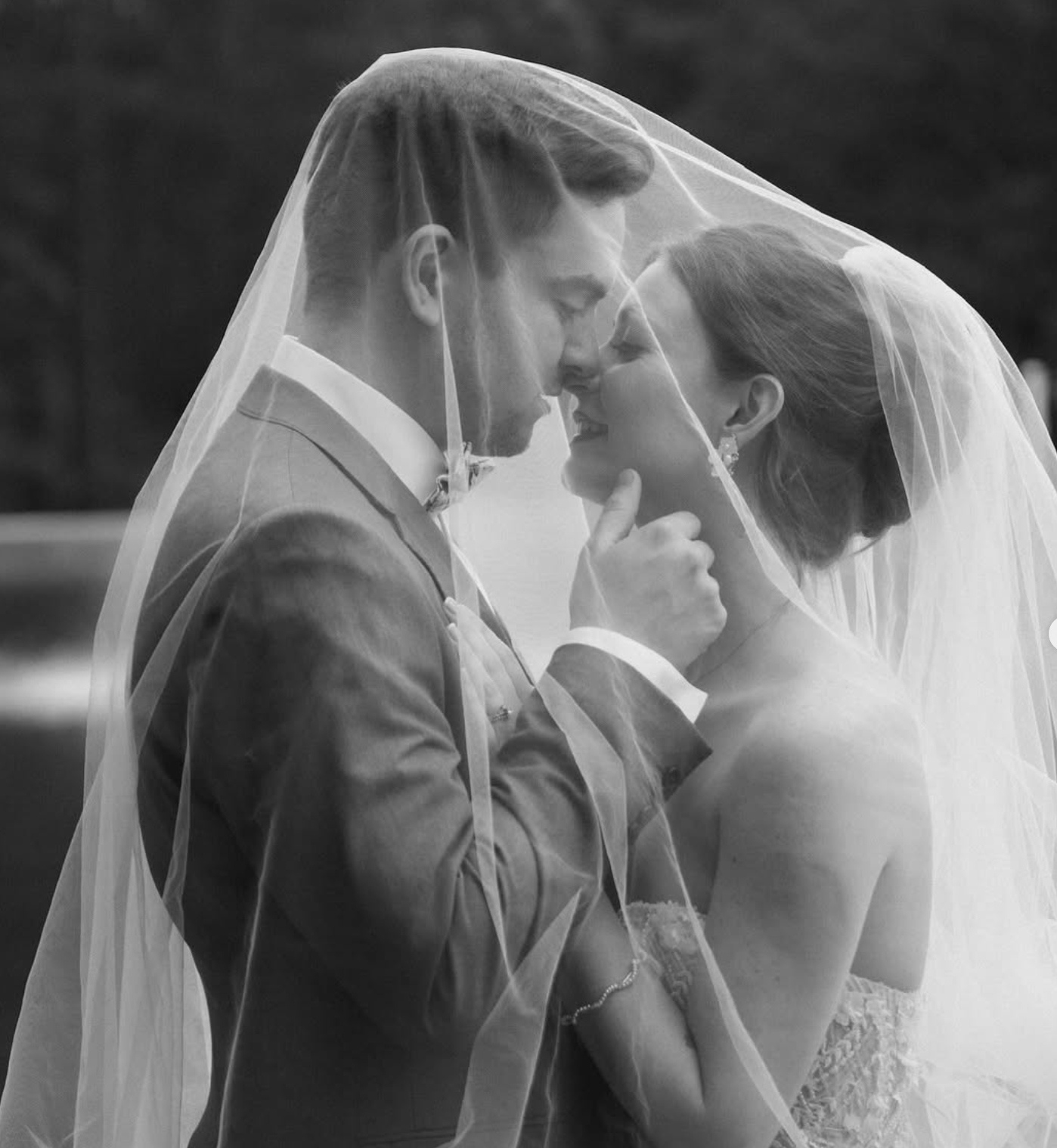 Bride and groom Gasparini sharing an intimate moment under the veil after their Savannah wedding.