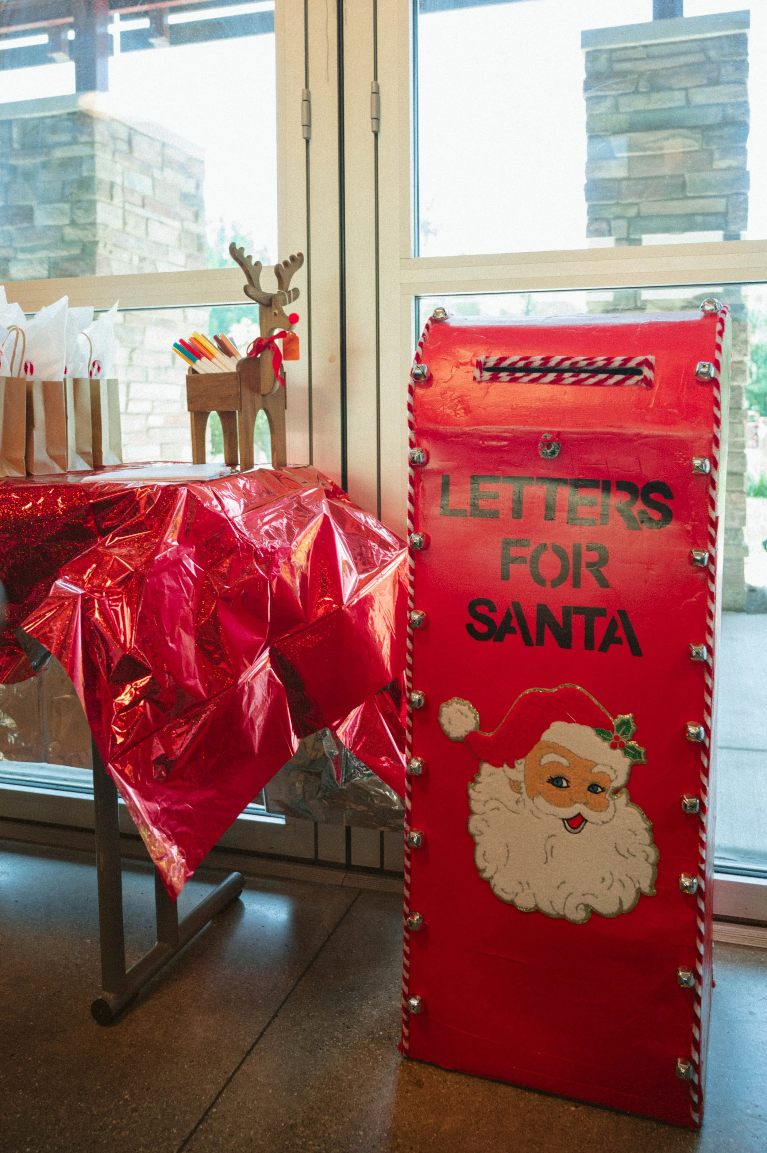 Red mailbox with the words "Letters for Santa" and an illustration of Santa Claus on it. DIY santa mailbox, DIY christmas decor, birthday party, christmas in july