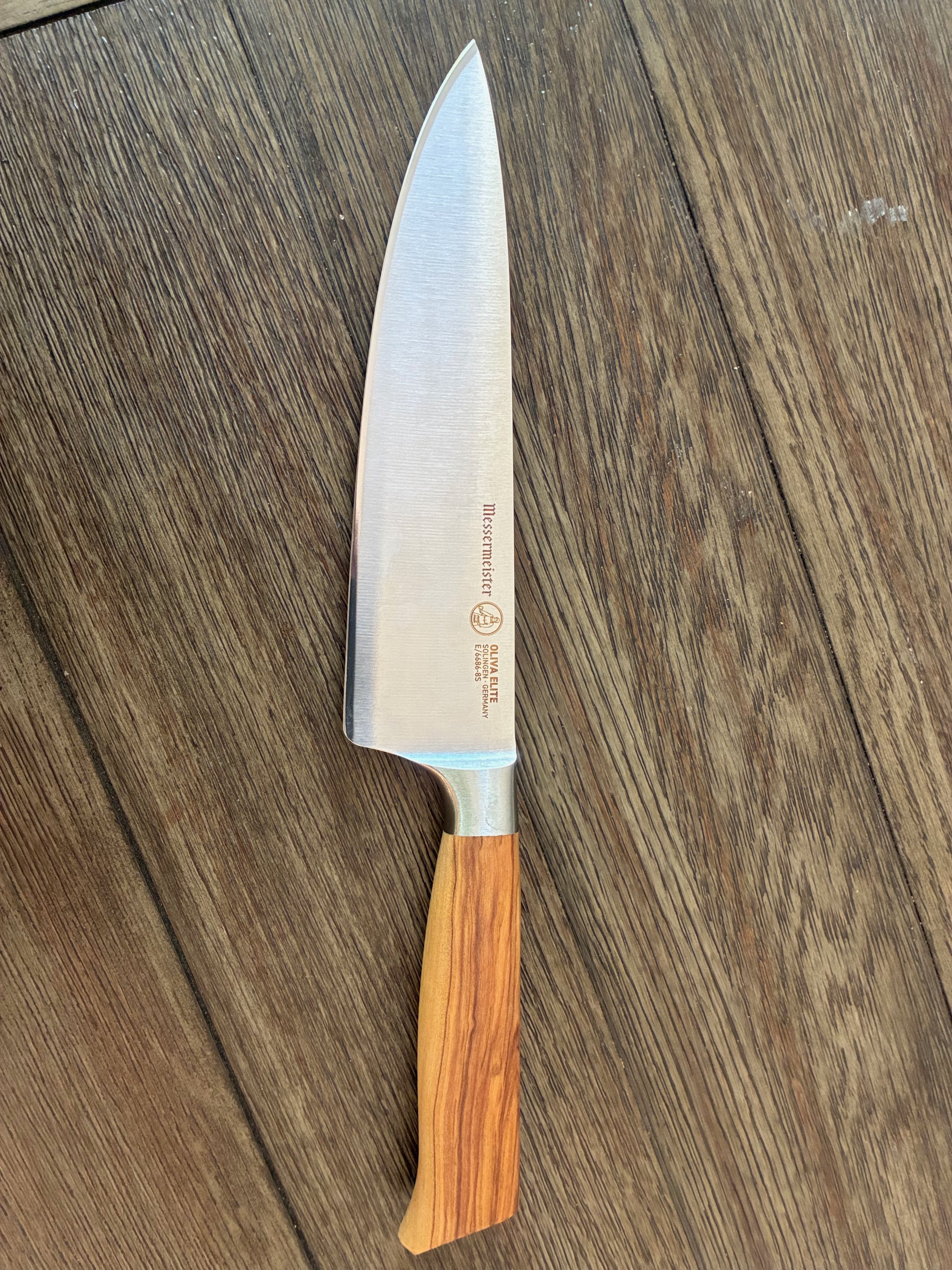 Freshly sharpened chef's knife with olive wood handle, sharpened by The Edge Haus in Cookeville, TN