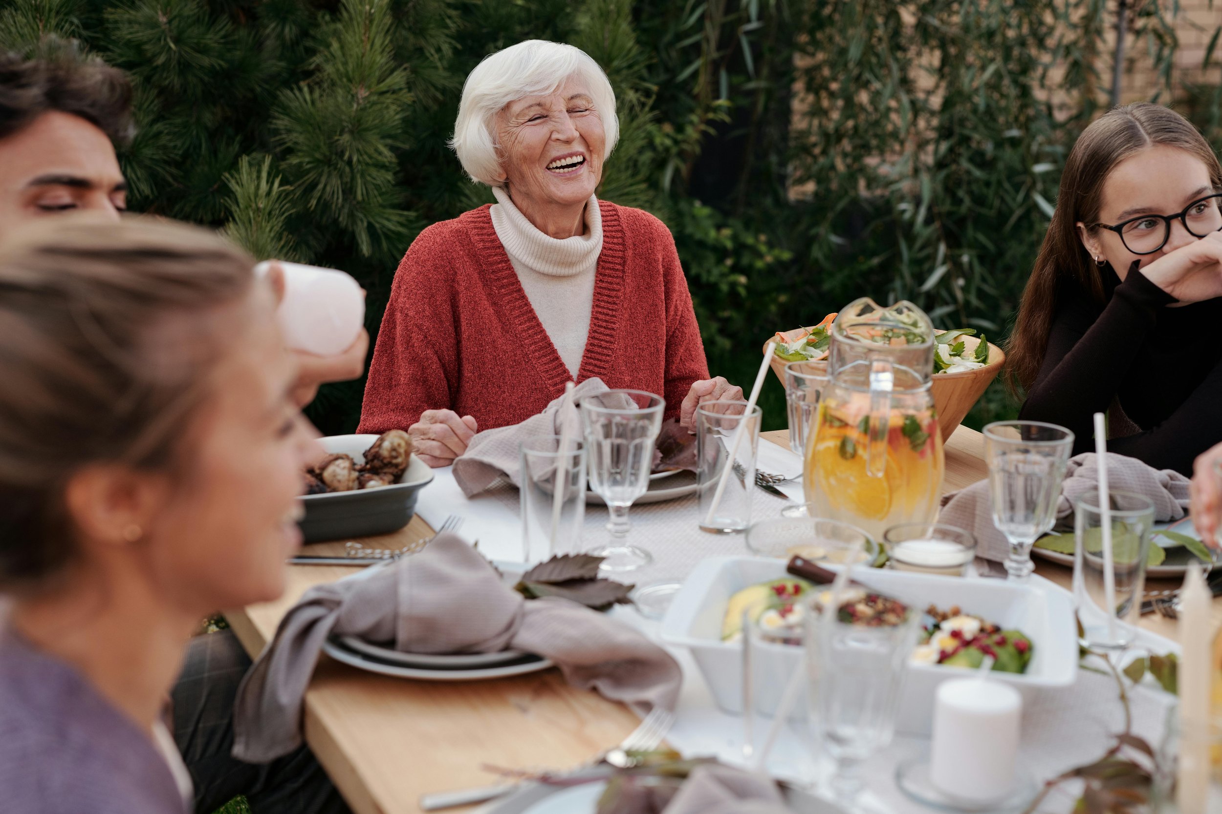 Woman sitting at table with family laughing