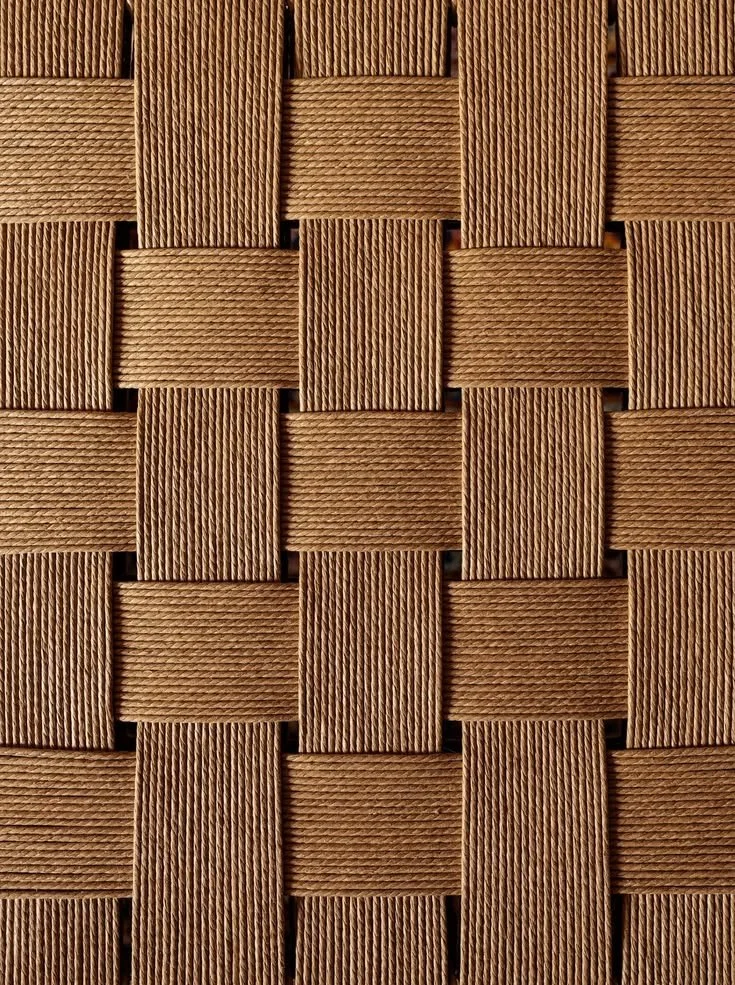 Close-up of a woven pattern made of wooden strips, forming a grid-like design.