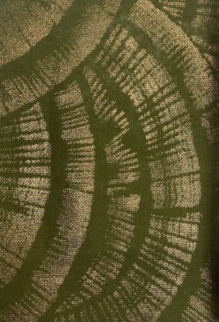 Close-up of a green fabric with a pattern resembling tree rings.