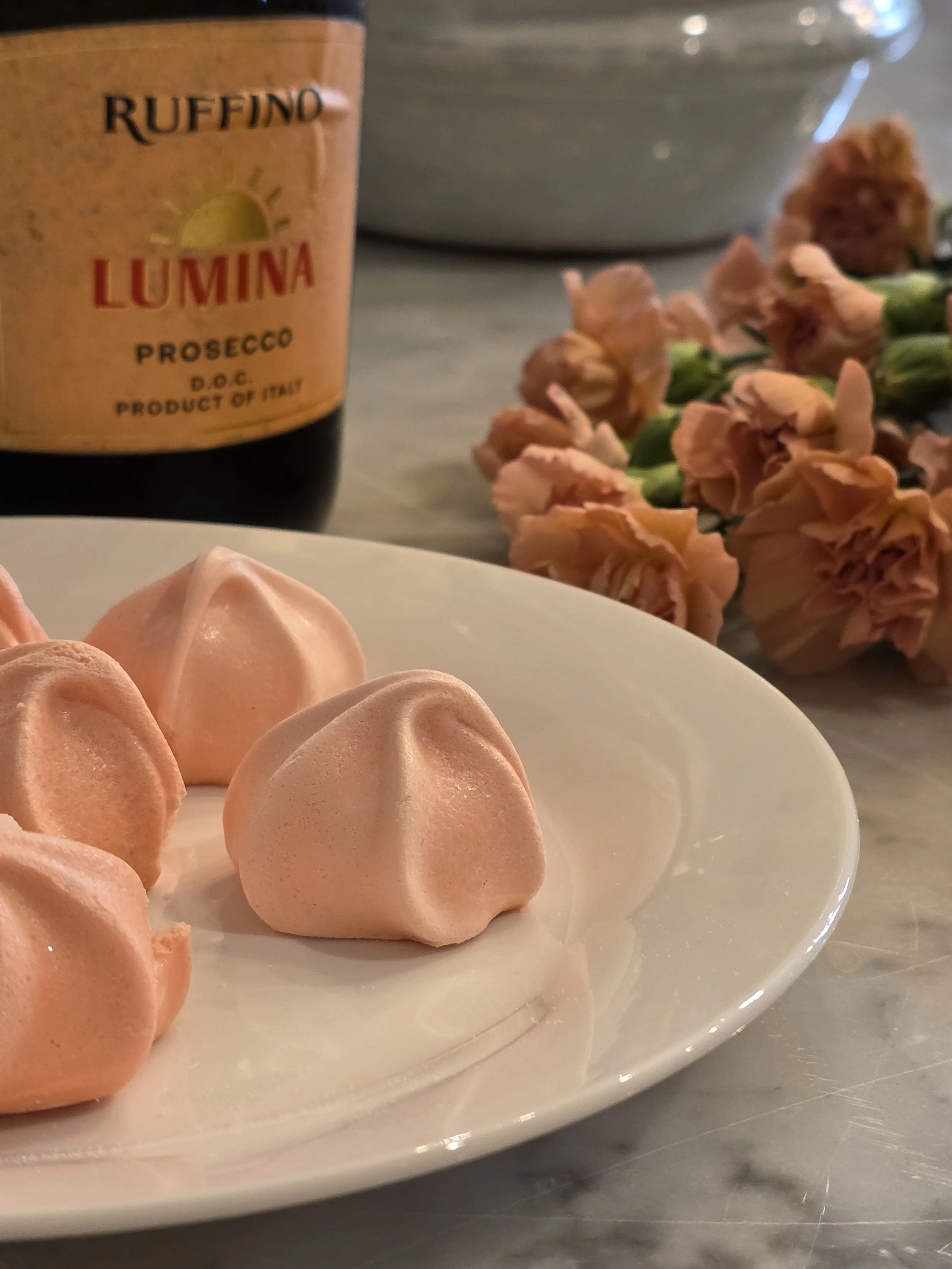 Flowers, sweets and sparkling wine waiting for guests on a counter