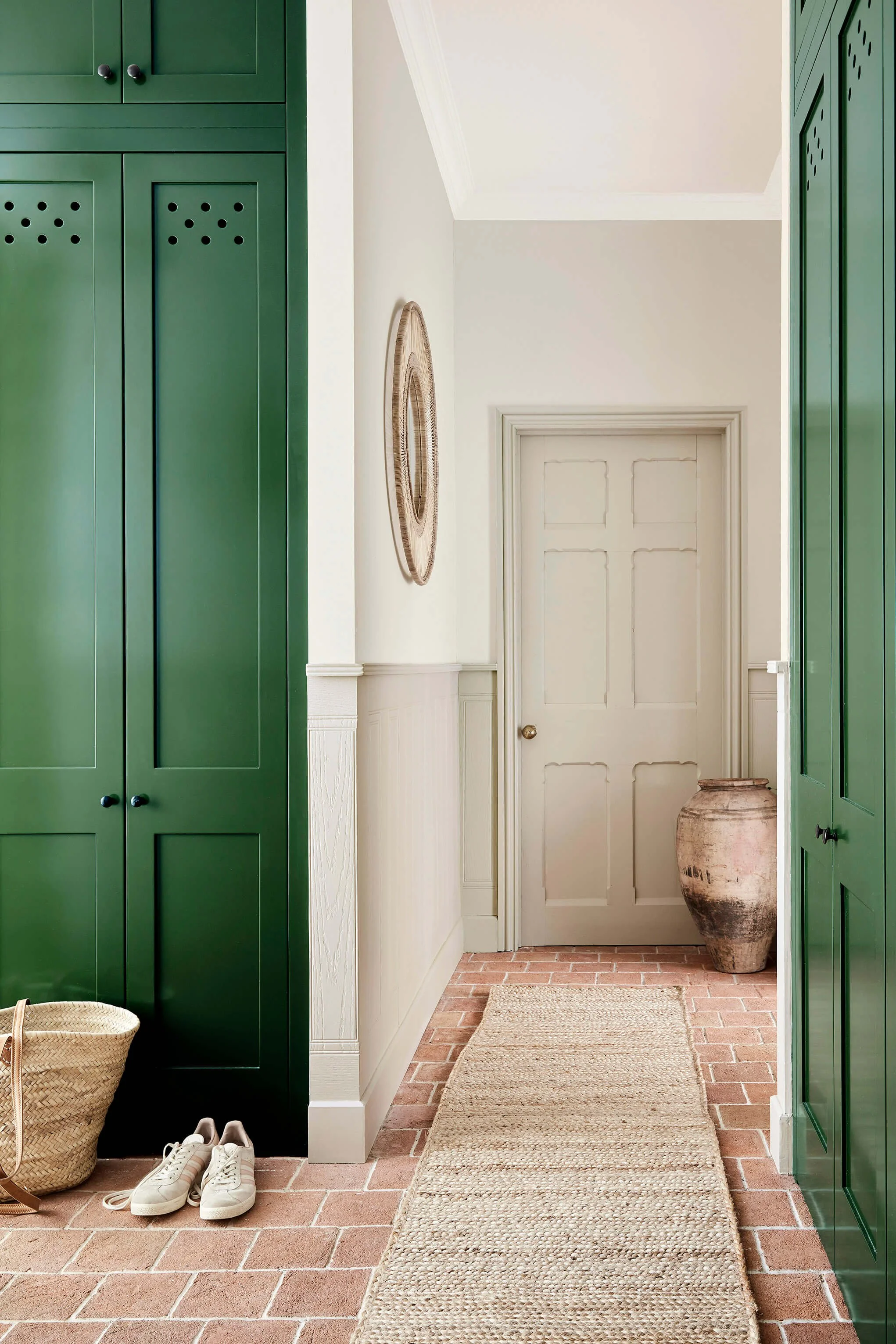 Green cabinets in hallway with portland stone family of colours from Little Greene Paint.