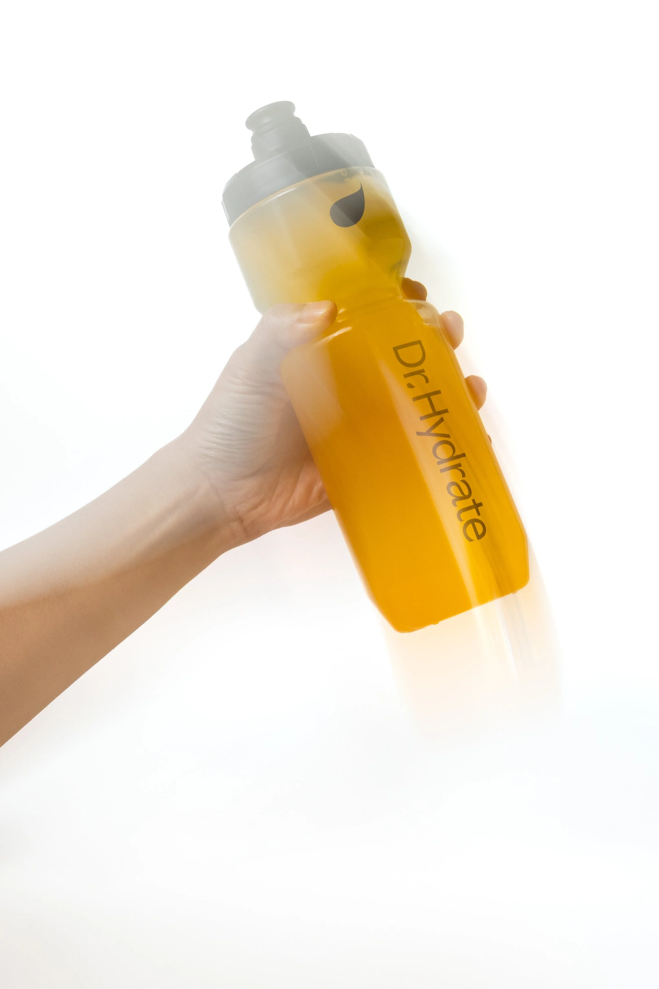 A hand holding a yellow water bottle with the text 'DryHelmet' written on it against a white background.