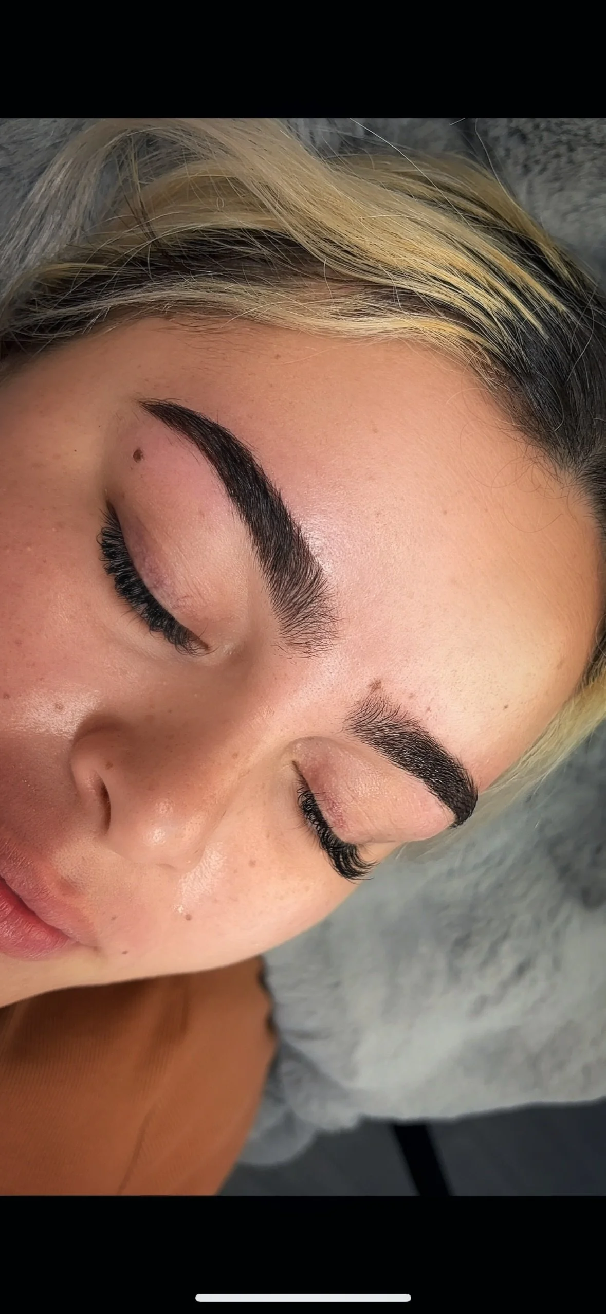 Eyebrows with dye coloring of brown.