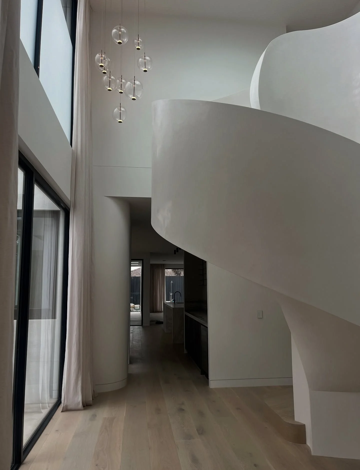 The entry at The Gordon, in Black Rock, opens to a grand void of soft curves and full-height curtains. A space created to draw you in.

#interiordesign #entry #design #void #stairs #curtain #interiors #home #homedesign #living