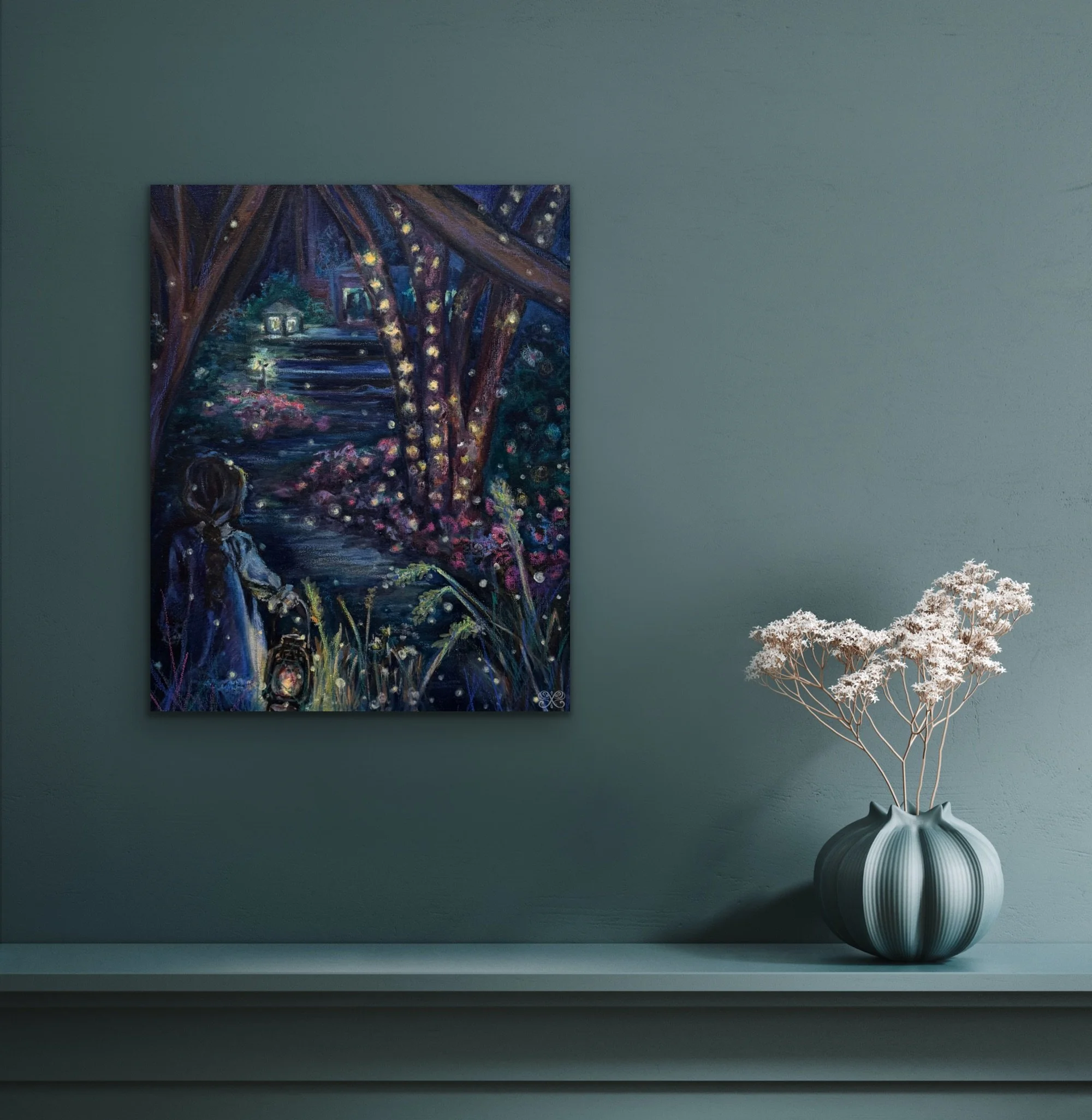 A painting hanging on a teal wall depicting a girl sitting by a river under a bridge illuminated by hanging lights, with a house and trees in the background. A vase with white dried flowers is placed on a ledge below the painting.