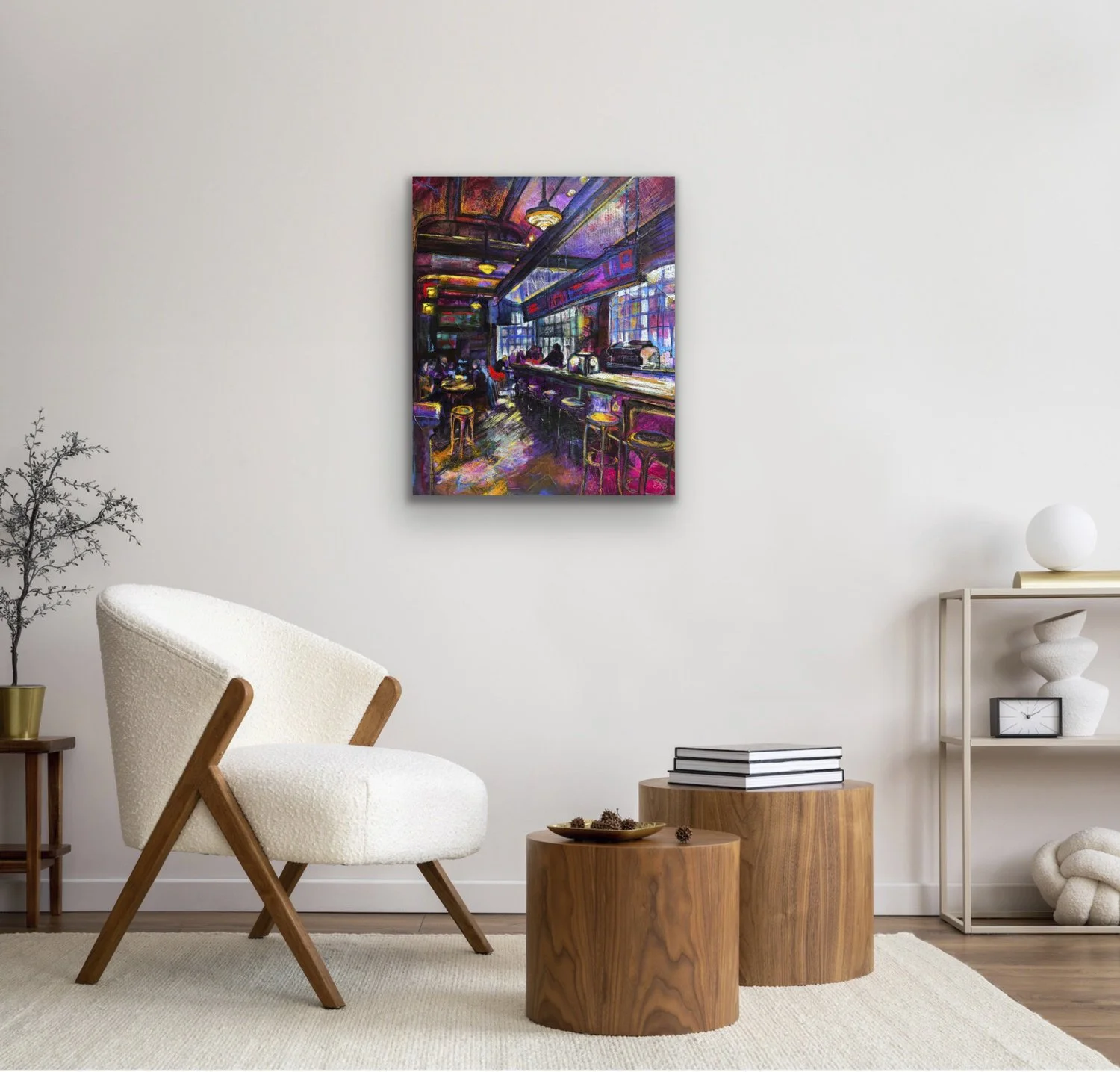 Colorful abstract painting hanging on a white wall in a minimalistic living room with white chair, wooden side tables, and modern decor.