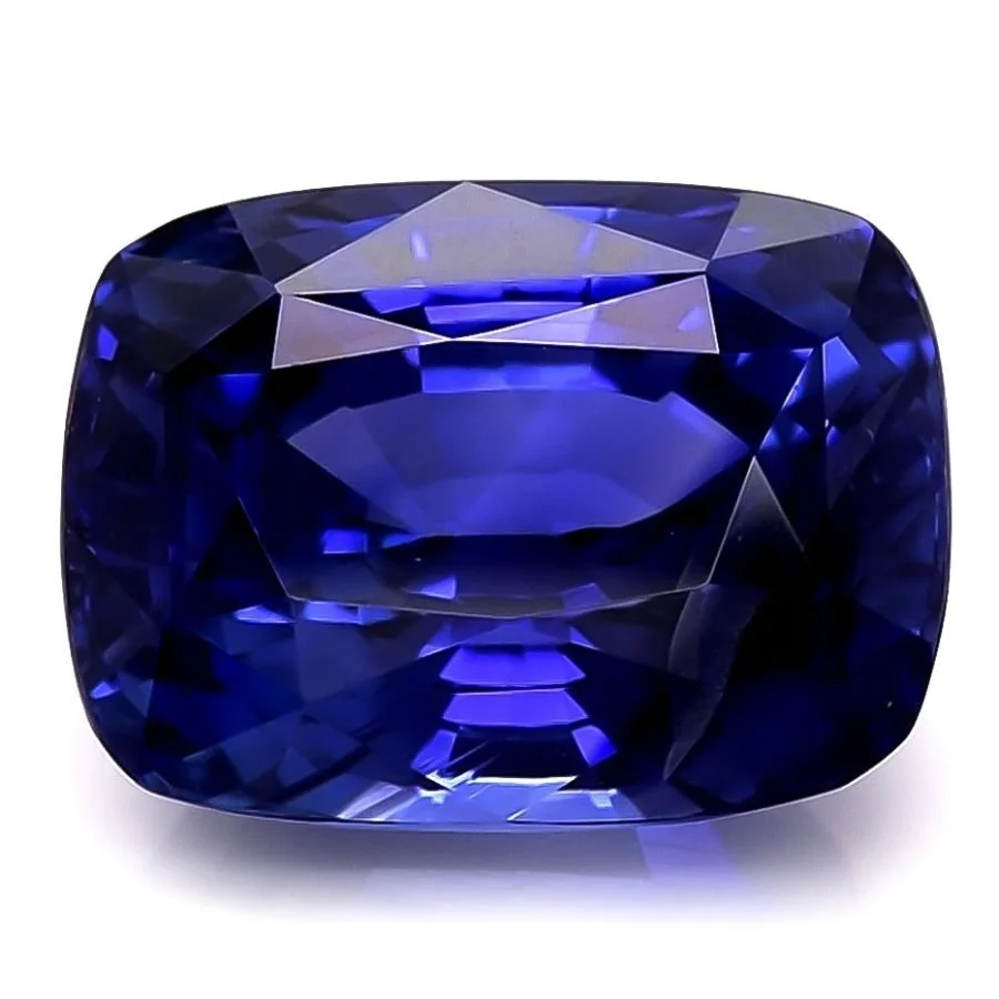 A large, cushion-cut, deep blue sapphire gemstone with brilliant facets.