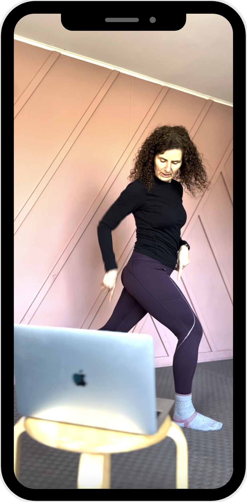 Screengrab from the Menopause Running Club facebook group showing Gabrielle dressed in athletic wear, holding dumbbells in both hands, posting about the 12 week runners strength programme that members are following. 