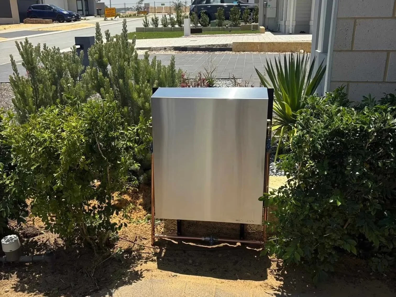 Pure₂O whole-house water filtration system installed at front of Perth home in Alkimos, stainless steel cabinet positioned at main water meter entry.