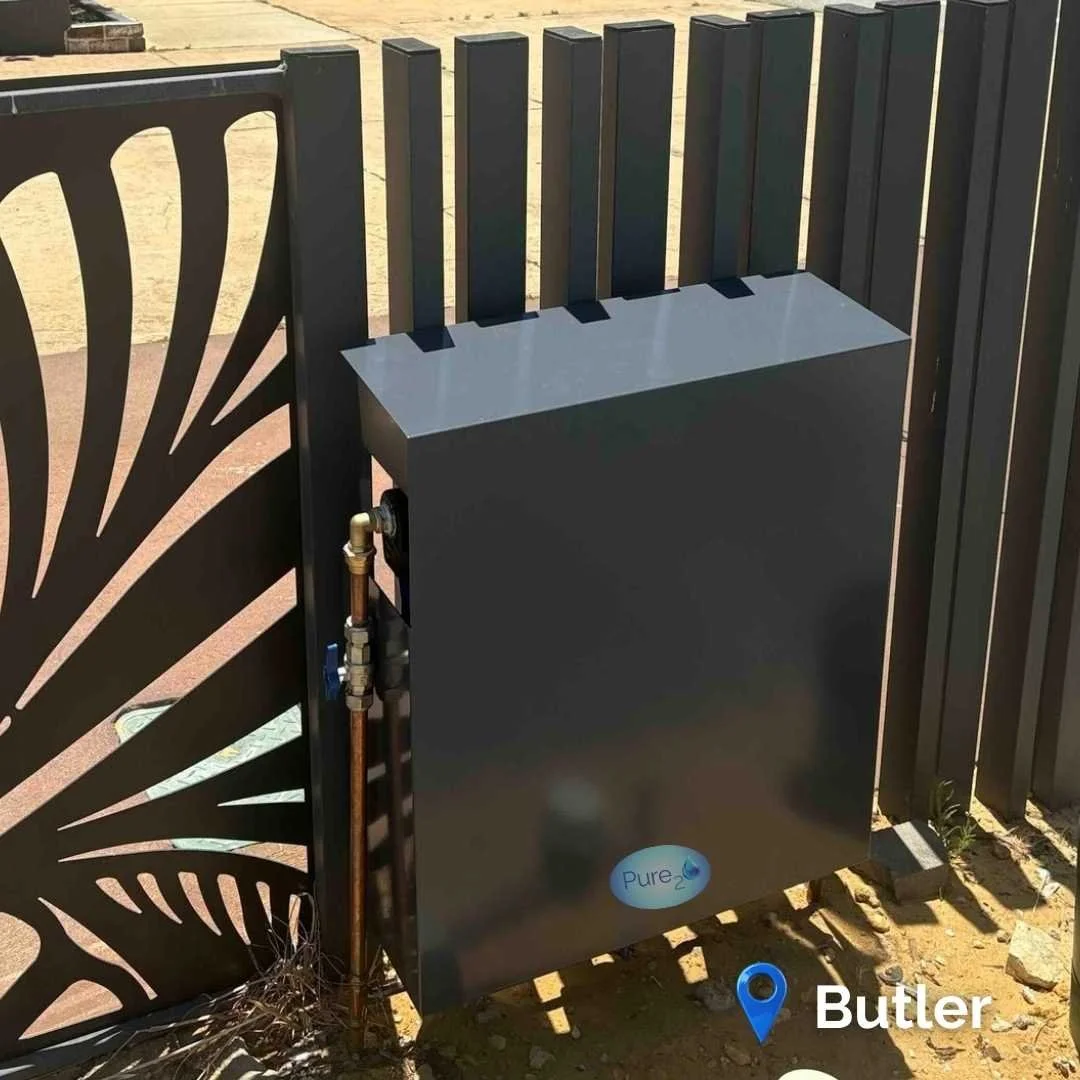 Pure₂O whole-house water filtration system installed in Butler WA with outdoor powder-coated cover protecting the 3-stage filtration system.