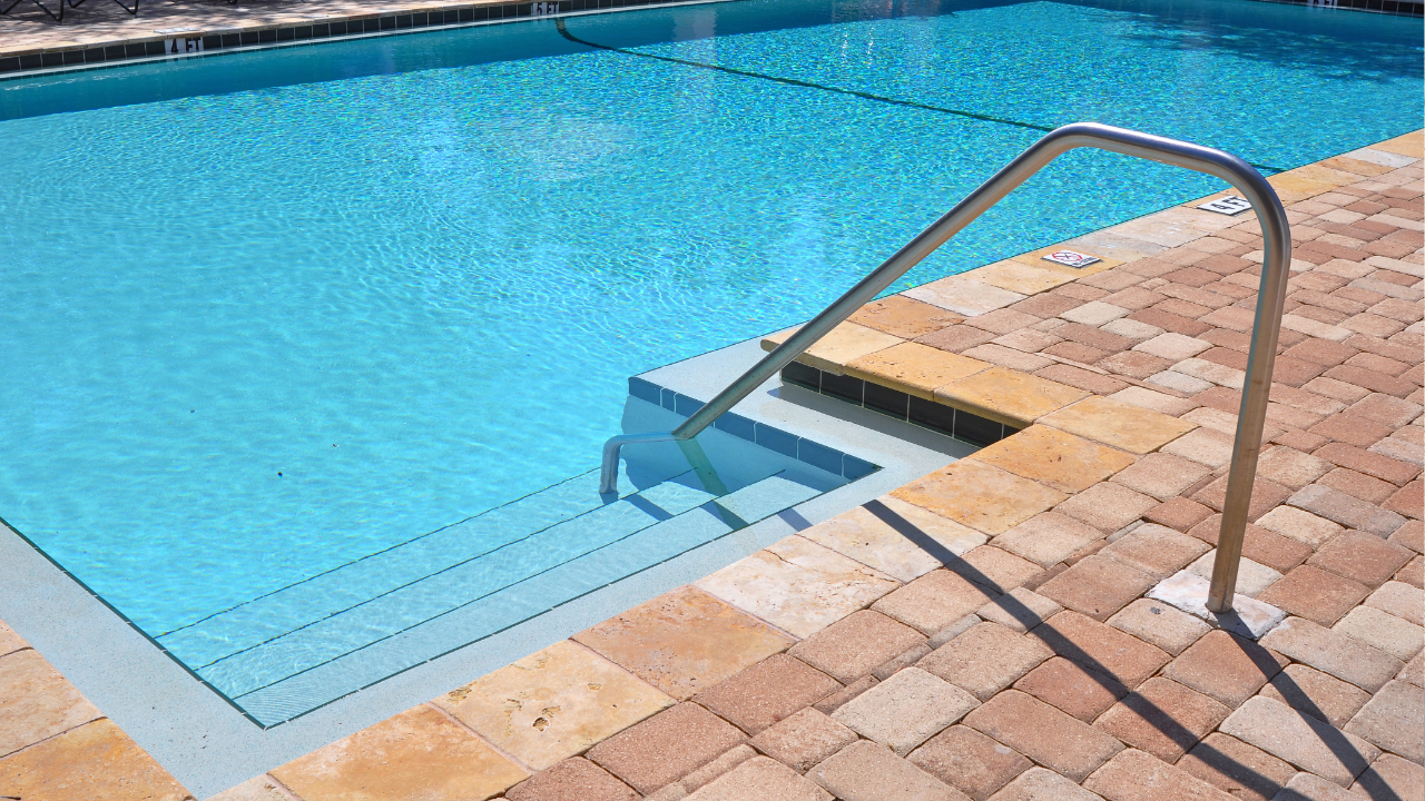 Pool with brick pavers surrounding it.