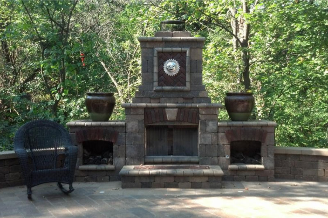 Custom stone paver outdoor fireplace in backyard setting..png