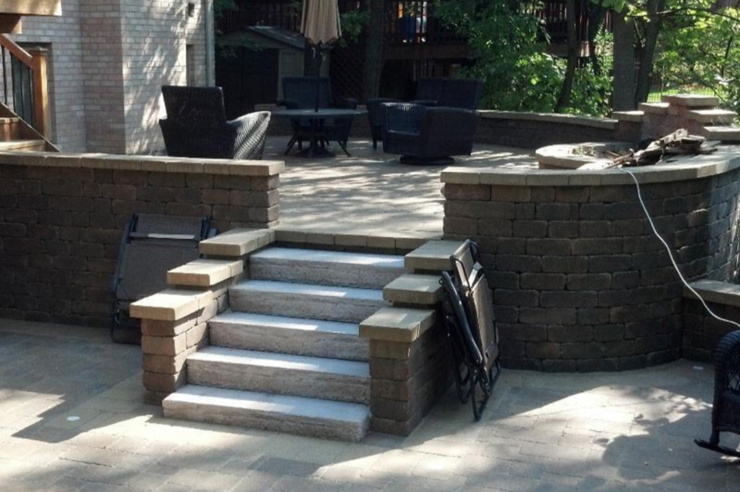 Stone paver steps leading to multi-level outdoor patio..png