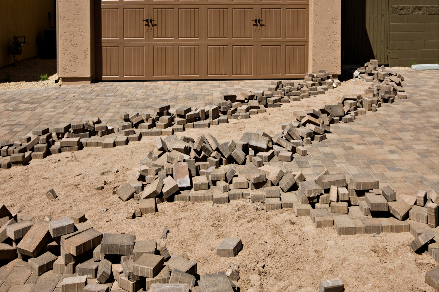 Why Drainage Is the Silent Killer of Brick Paver Driveways &amp; Patios