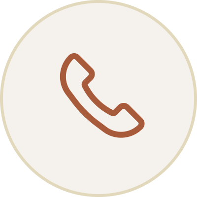 Icon of a mobile phone receiver inside a beige circular background.