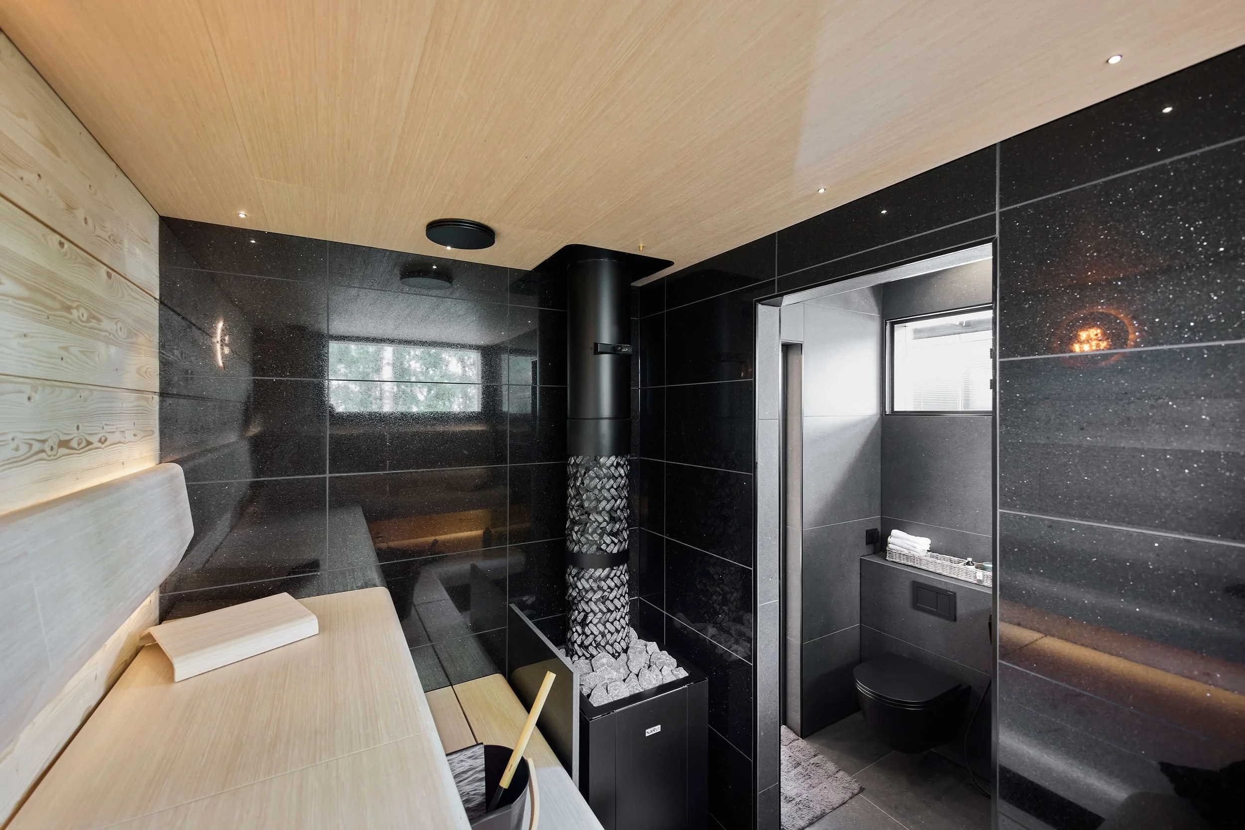 modern-black-sauna-with-light-colored-ceiling-and-benches.jpg