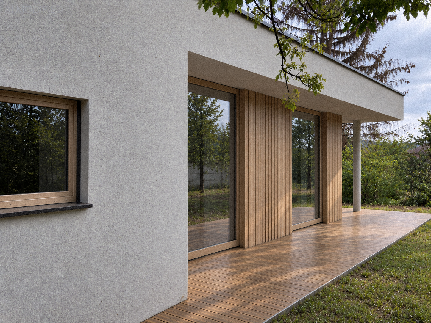 Modern house with white textured exterior wall, sliding glass doors with wooden frames, and a wooden deck, surrounded by greenery and trees.