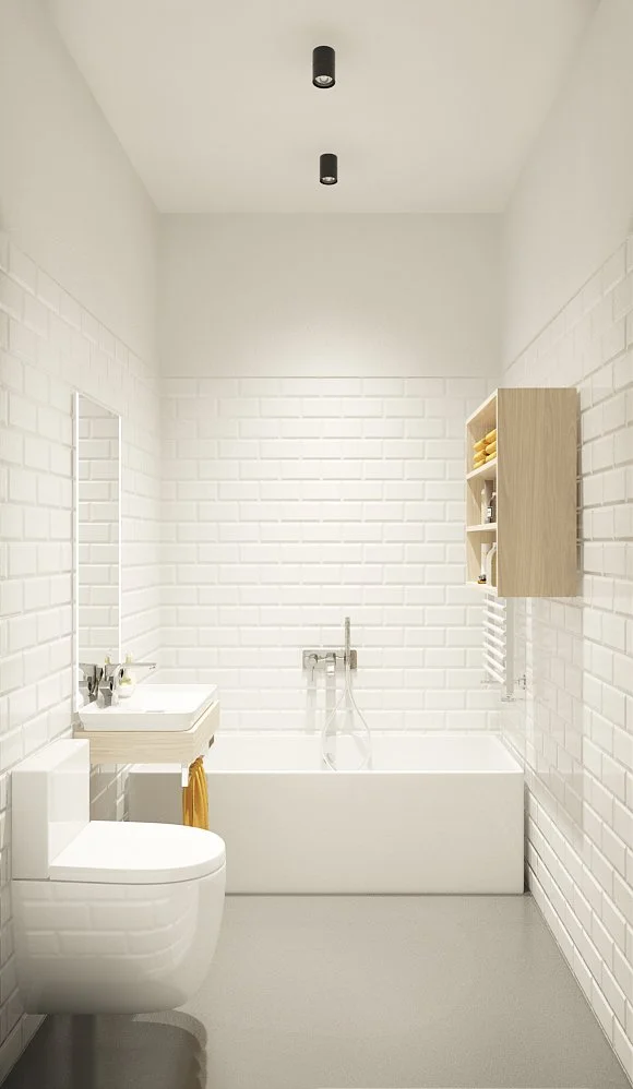 Modern minimalist white bathroom with brick-textured walls, a toilet, a small sink with a mirror, a bathtub with a wall-mounted faucet, and a wooden wall cabinet.