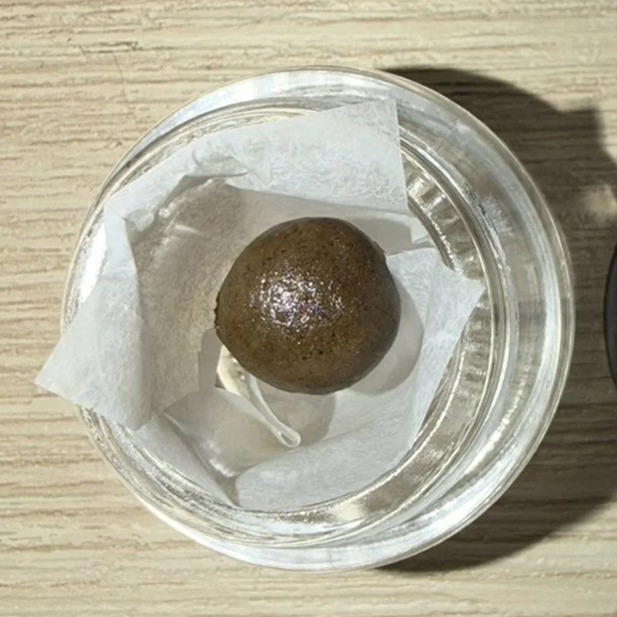 Static sift hash ball — glossy, pliable texture close up
