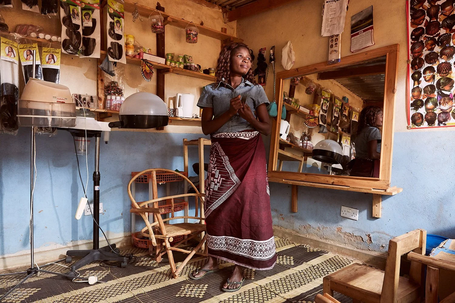 Chrissy stands in her hair salon, Mpyupyu.