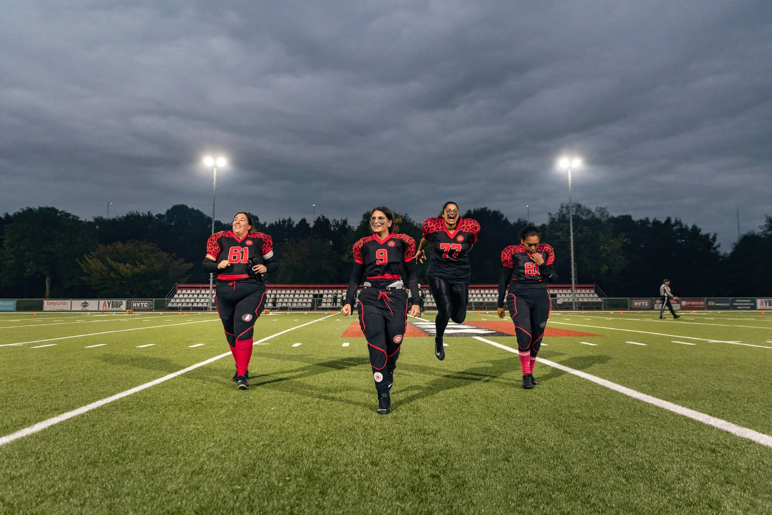 Left to right: Amsterdam Cats center Michelle, quarterback Kelly, center guard Sitara and defensive back Rufina walk back to the rest of the team after winning the coin toss before the first and only game of the 2020-2021 season against the Rotterdam