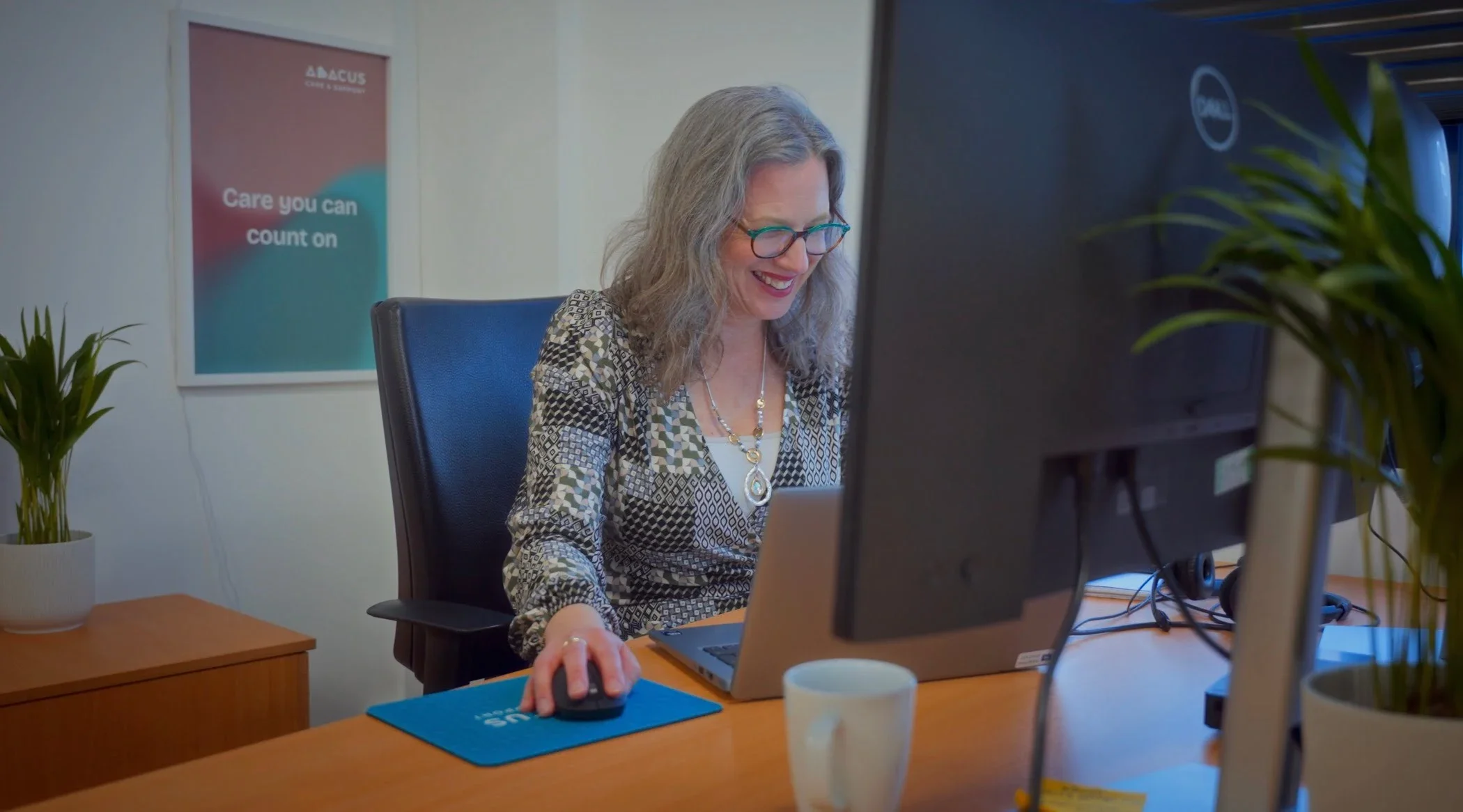 A member of staff browsers on the computer.