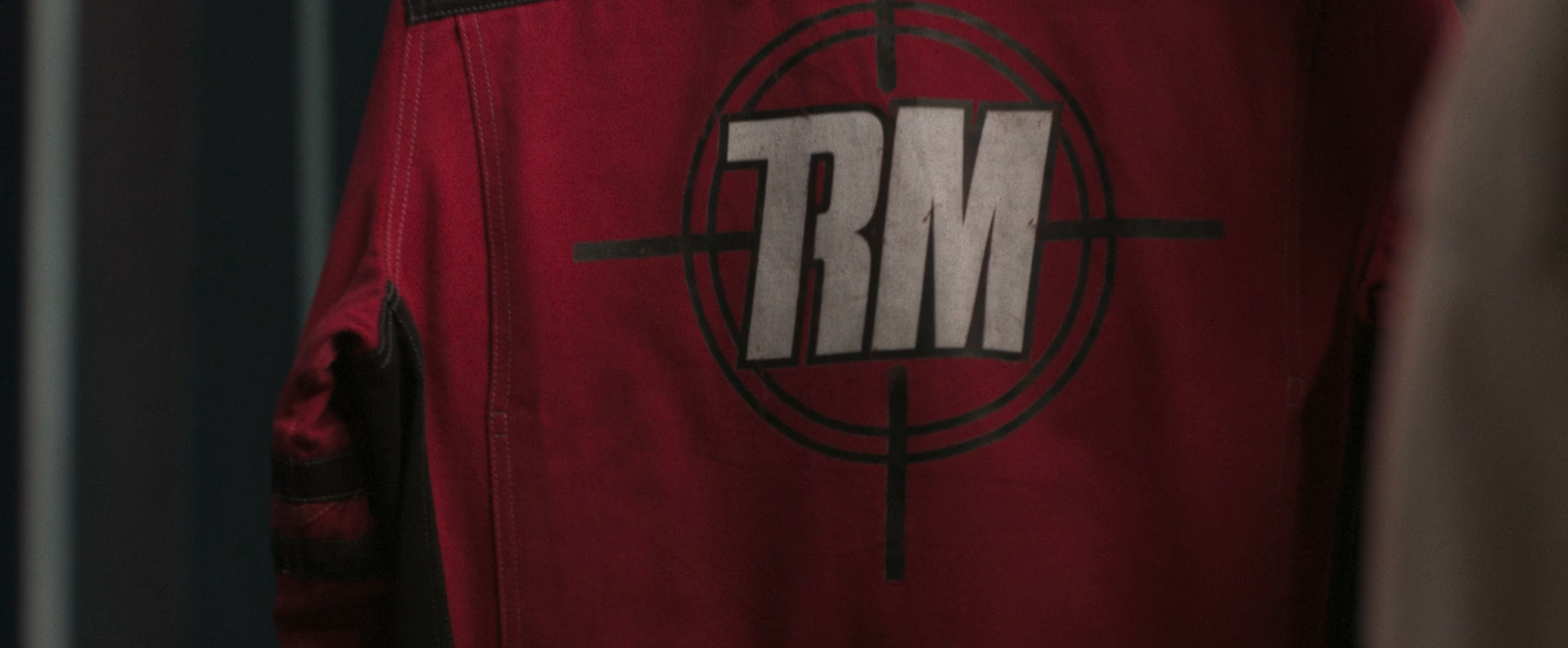 The Running Man logo – crosshair acronym variant. Seen here on the hero Running Suit. 