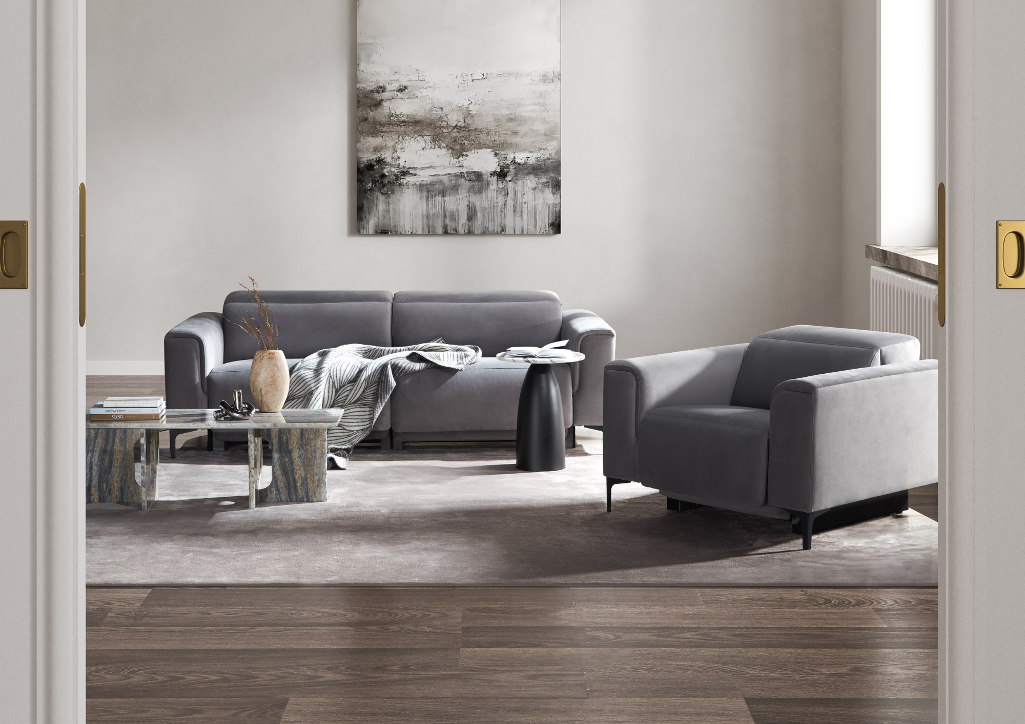 Living room with gray sofas, a marble coffee table, and a large abstract black and white painting on the wall.