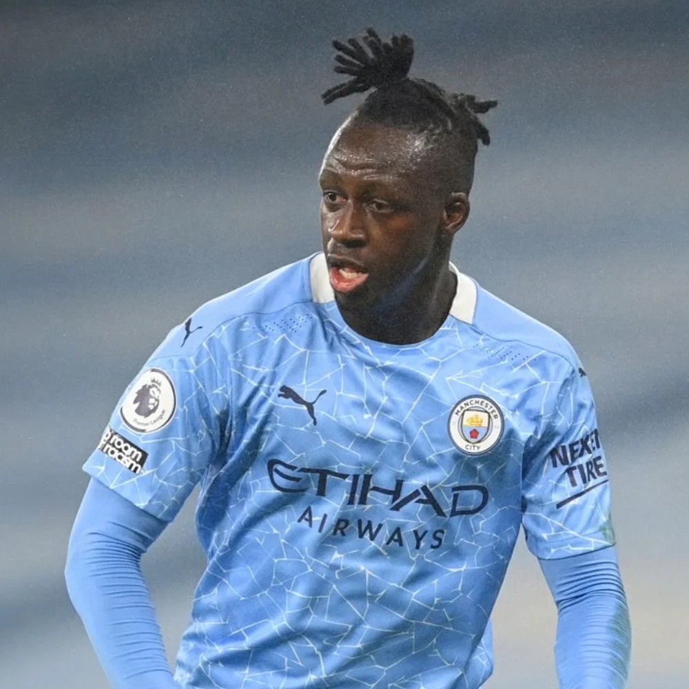 A soccer player wearing a Manchester City jersey during a game.