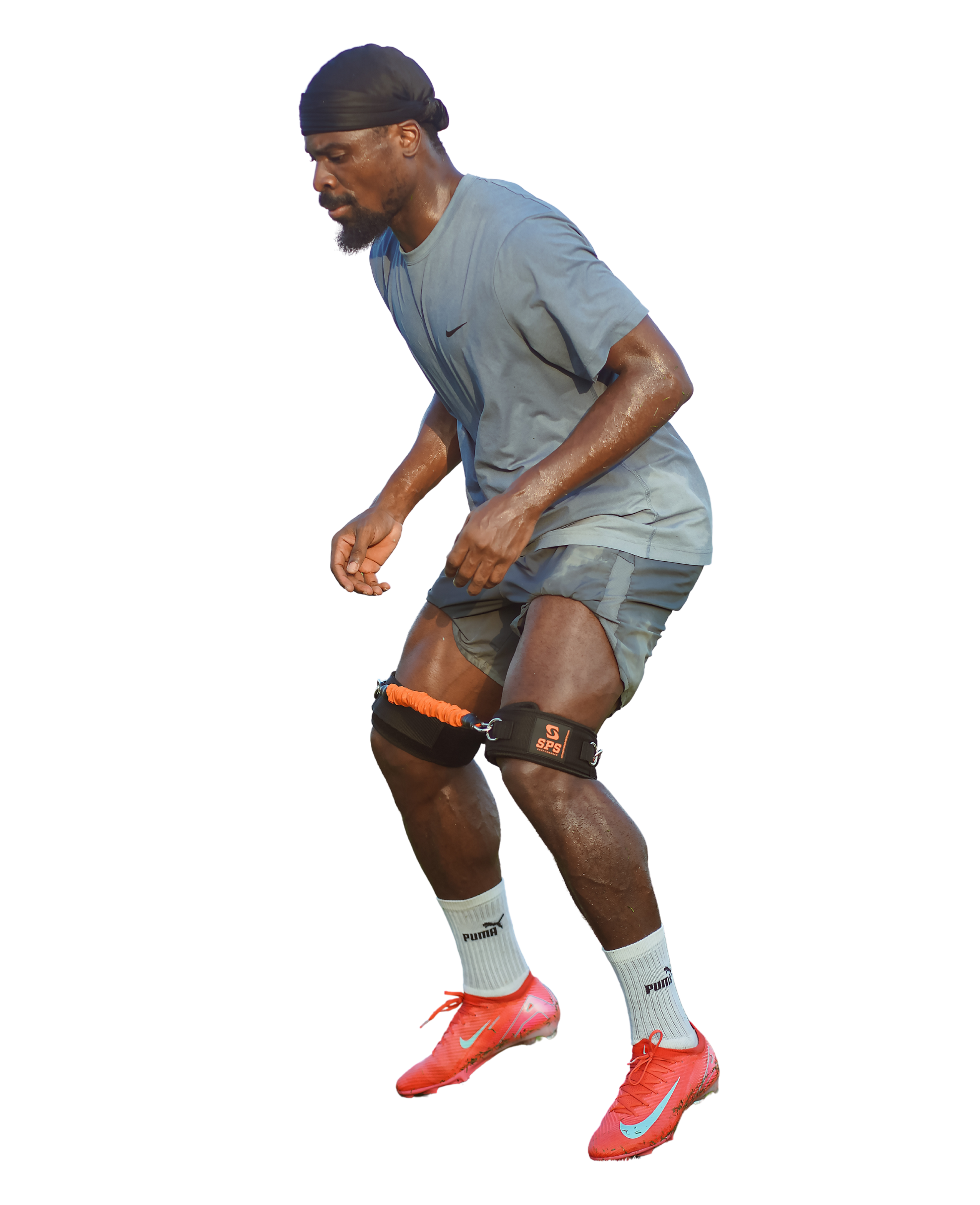 Athlete sprinting with knee brace and sweat, wearing Nike shoes and Puma socks.