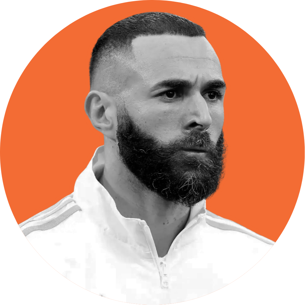 Black and white portrait of a man with a full beard and short hair, wearing a white sports jacket, on an orange background.