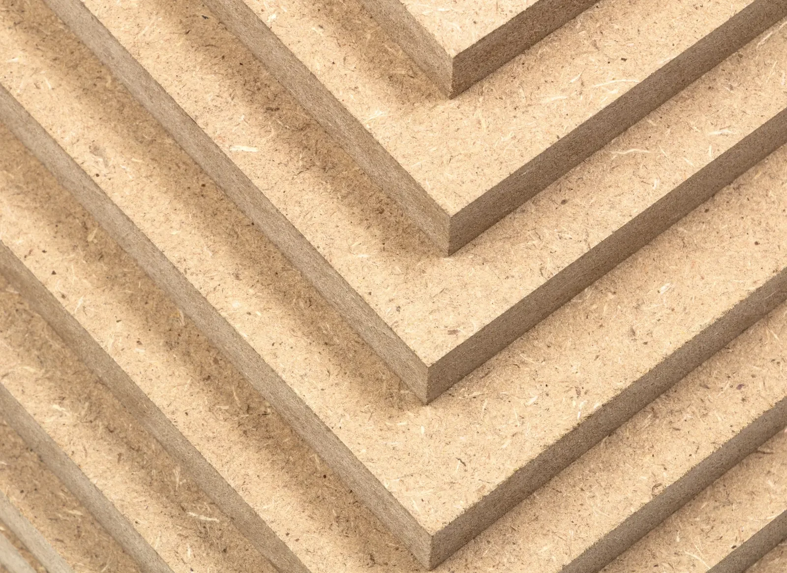 Close-up of a MDF wooden panels with evenly spaced grooves.