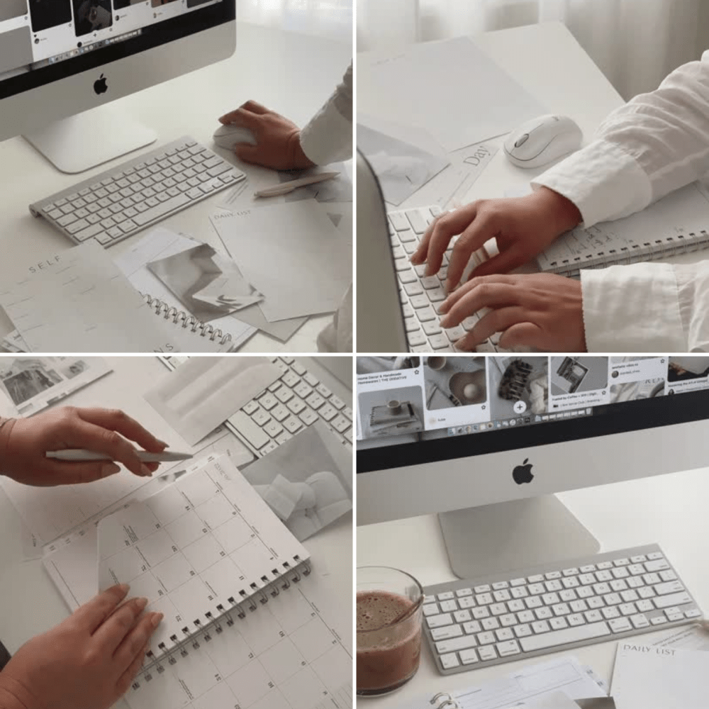 People working at a desk with a computer, keyboard, mouse, papers, notebooks, a drink, and a wireless keyboard.